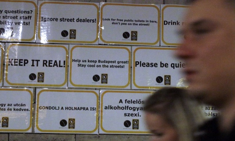 Tourists walk past posters with advice from locals in downtown Budapest September 16, 2017. u00e2u20acu201d AFP pic