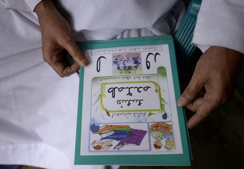 Myanmar Rohingya Islamic scholar Muhammed Hanif shows an example of a textbook as he speaks during an interview with AFP in the Bangladeshi area of Coxu00e2u20acu2122s Bazar October 20, 2017. u00e2u20acu201d AFP pic