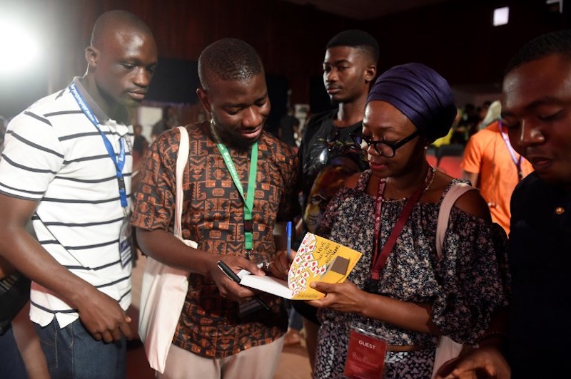 Author of u00e2u20acu02dcLove Does Not Win Electionu00e2u20acu2122 Ayisha Osori (right) signs autographs during the Ake Arts and Book festival in Abeokuta, southwest Nigeria, November 17, 2017. u00e2u20acu201d AFP pic