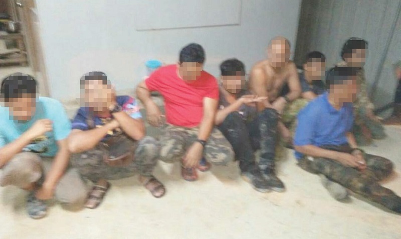 The eight men detained by police for shooting livestock with assault weapons in Kampung Ulu Lakai, Jelebu, on Wednesday. u00e2u20acu201d Malay Mail pic
