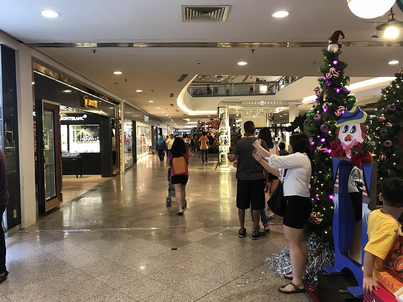A woman takes a selfie in front of some Christmas decorations at Mid Valley Megamall in Kuala Lumpur. — Picture by A. Ruban