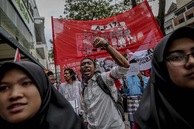 Participants shout slogans as they take part in a march to commemorate the 71st anniversary of the formation of Angkatan Pemuda Insaf in Kuala Lumpur December 23, 2017.
