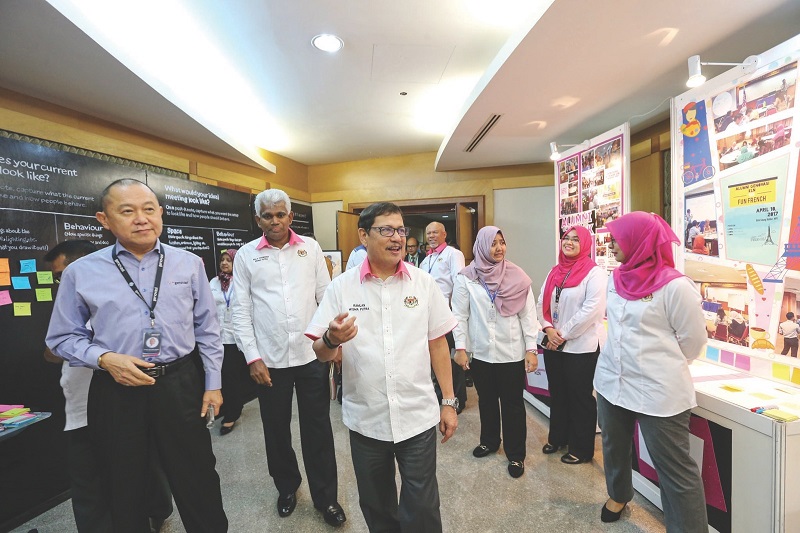 Ramlan and Lee (left) on a walkabout of the Genovasi booth during the Foreign Affairs Ministry Innovation Day event at Wisma Putra, Putrajaya yesterday. u00e2u20acu201d Picture by Ahmad Zamzahuri