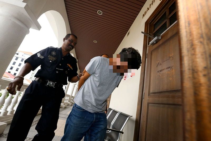 The 50-year-old trader is escorted by police officers into the Penang Session Court compound after he was charge for raping his own daughter who is now pregnant. u00e2u20acu201d Picture by Sayuti Zainudin