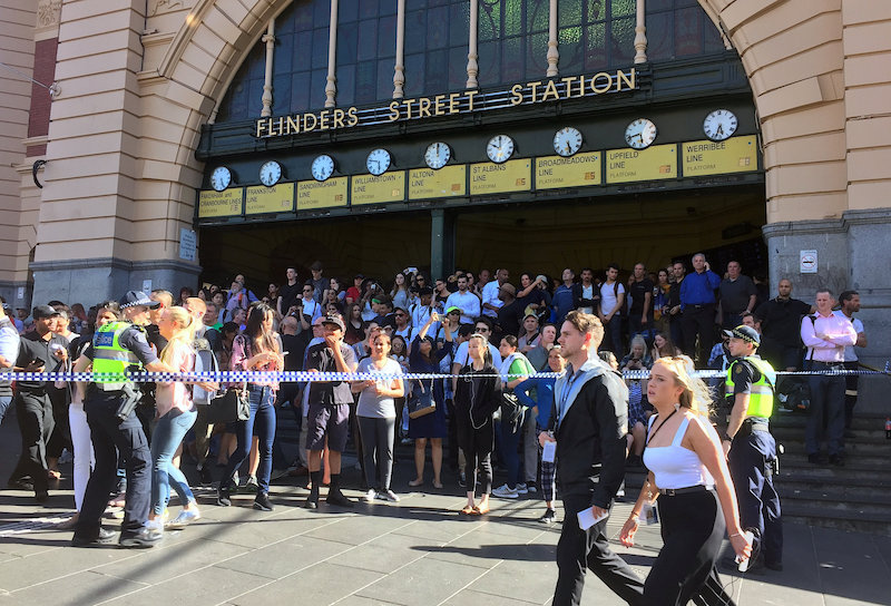 Members of the public stand behind police tape after Australian police said they have arrested the driver of a vehicle that ploughed into pedestrians at a crowded intersection in Melbourne December 21, 2017. u00e2u20acu201d Reuters pic