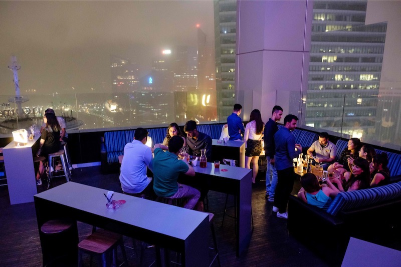 This picture taken on December 31, 2017 shows guests having drinks at the Skyline bar overlooking the city-state's financial district in Singapore. u00e2u20acu201d AFP pic