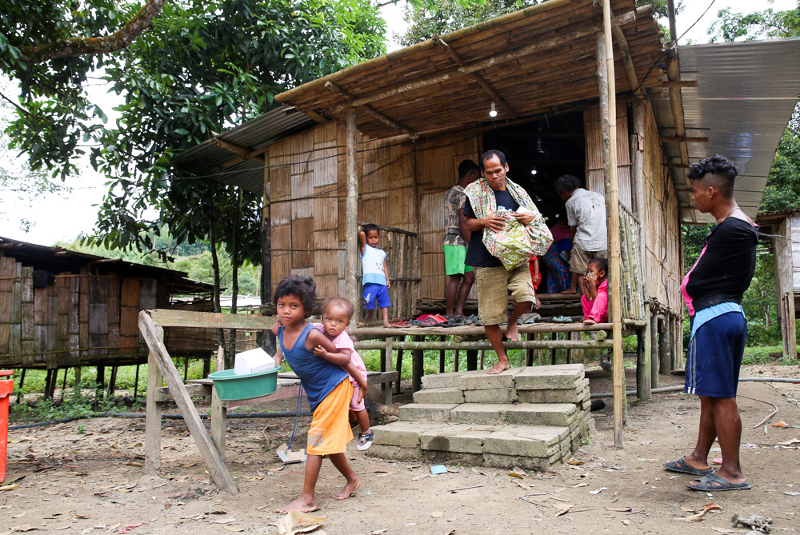 A man with a sarong full of Christmas goodies leaving the church building in Kampung Rangan. u00e2u20acu201d Picture by Choo Choy May