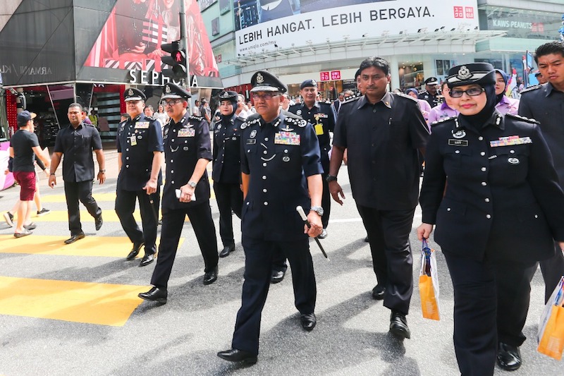 Fuzi takes a stroll along Jalan Bukit Bintang before the launch of the Crime Prevention: Snatch Theft and Pickpockets campaign. u00e2u20acu201d Picture by Ahmad Zamzahuri