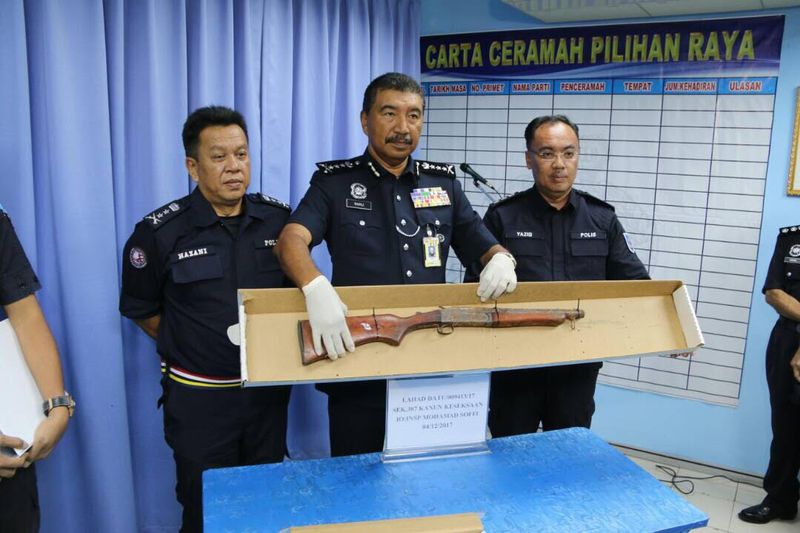 Sabah police commissioner Datuk Ramli Din showing off a pump gun that had been recovered next to the dead suspect. u00e2u20acu201d Picture  courtesy of ESSCOM