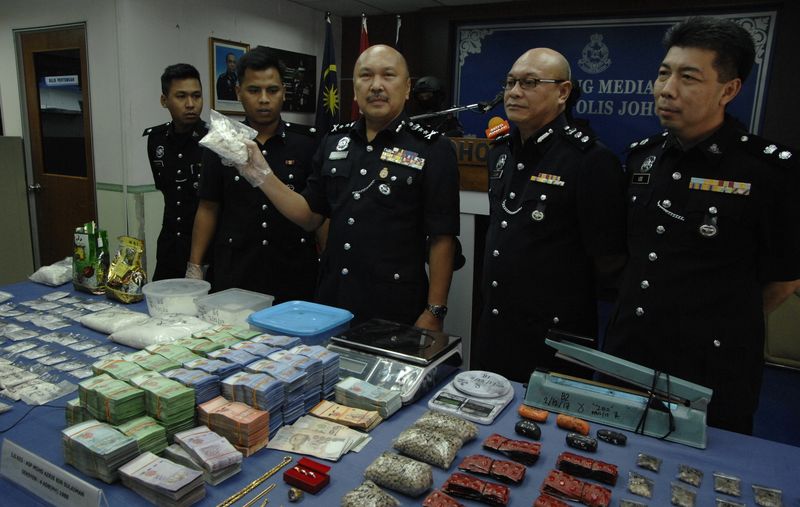 Johor deputy police chief Datuk Mohd Kamarudin Md Din (third left) and senior officers showing the seized drugs by Bukit Amanu00e2u20acu2122s STING group during a series of raids in Johor Baru, December 4, 2017. u00e2u20acu201d Malay Mail/Roslan Khamis pic