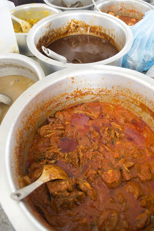 Ayam masak merah and other pots of curries are pictured at the Nasi Tomato Sungai Nyior stall.