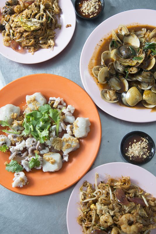 Char Koay Teow with side dishes of clams and steamed baby octopus.