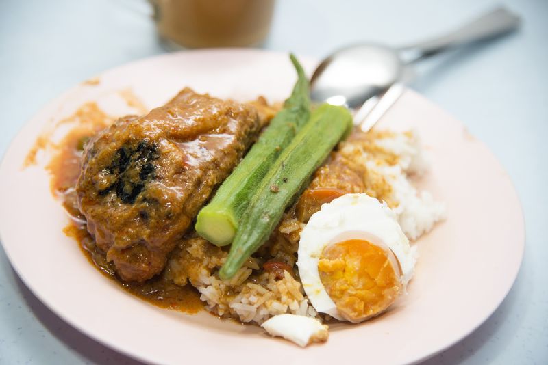 Nasi kandar overflowing with gravy at the Jamal Mohamed Nasi Kandar stall.
