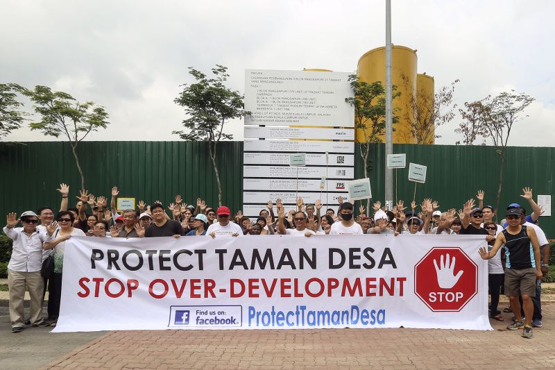 Taman Desa residents are seen holding a banner at The Address's project site to urge for a halt of the alleged over-development of the mature neighbourhood. u00e2u20acu2022 Picture by Yusof Mat Isa