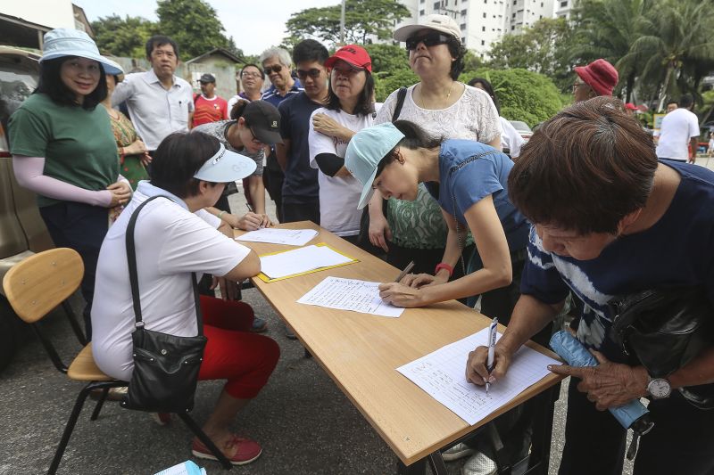 Taman Desa residents are seen signing a memorandum during a protest against a new condominium project at their neighbourhood in Kuala Lumpur. ― Picture by Yusof Mat Isa
