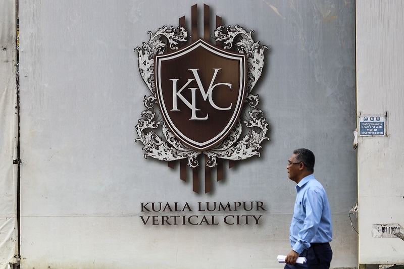 A man walks past a billboard showing the logo of Kuala Lumpur Vertical City (KLVC) in Jalan Semarak, Kuala Lumpur. u00e2u20acu201d Picture by Yusof Mat Isa