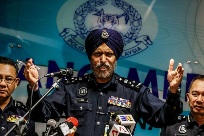 Datuk Amar Singh displaying several seized Macau scam equipment during his first press conference as CCID director at the department headquarters on Tuesday afternoon. u00e2u20acu201d Picture by Hari Anggara