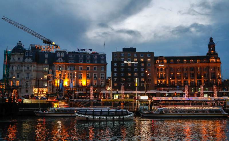 Tourist boats are illuminated while cruising on a canal in central Amsterdam November 30, 2017. u00e2u20acu201d Reuters pic 