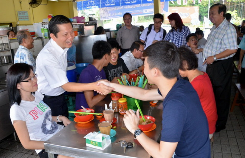 File picture shows Barisan Nasional (BN) candidate for N.45 Elopura state seat, Au Kam Wah sharing a light moment with the voters at Elopura market, in Sandakan, April 22, 2013. u00e2u20acu201d Bernama pic