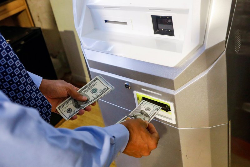 A man feeds money into a Bitcoin ATM at the Bitcoin Center NYC in New York November 27, 2017. u00e2u20acu201d Reuters pic 