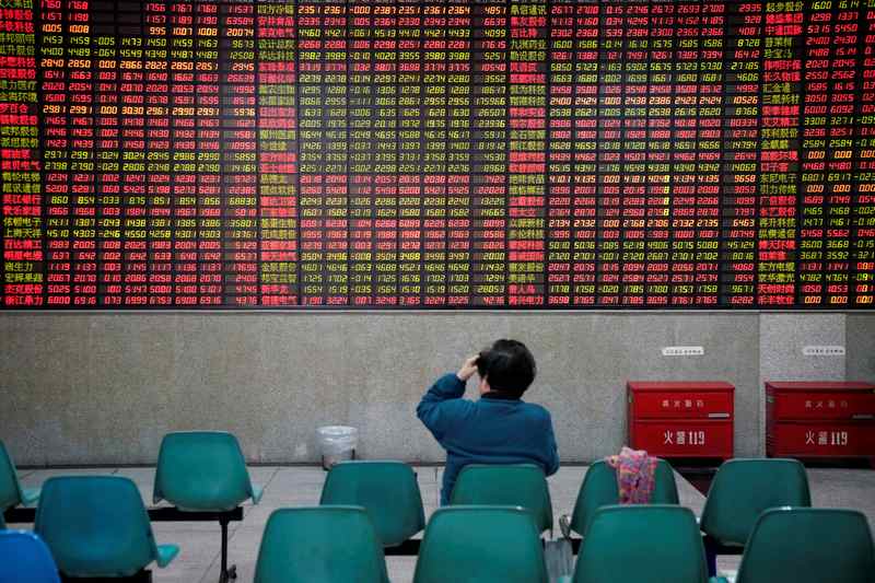 An investor looks at an electronic board showing stock information at a brokerage house in Shanghai November 24, 2017. u00e2u20acu201d Reuters pic