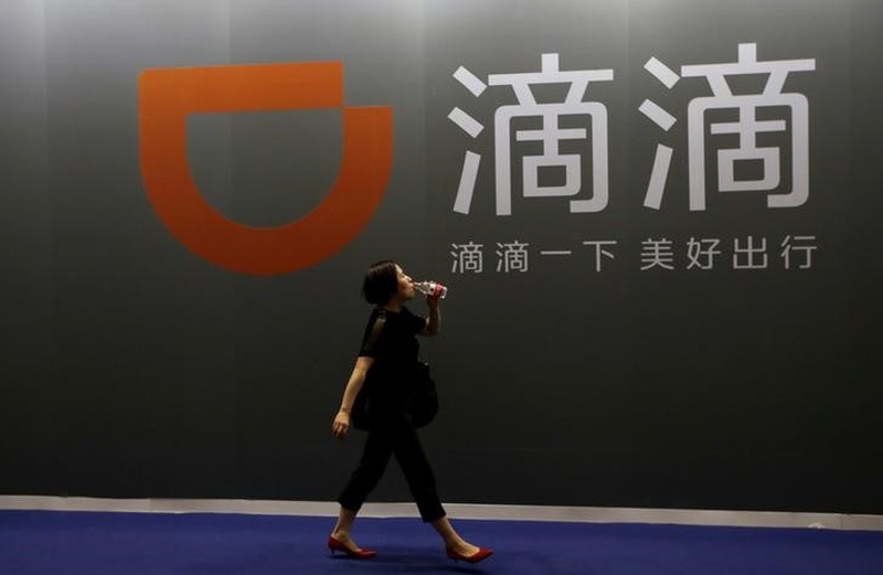 A woman walks past Didi Chuxing's booth at the Global Mobile Internet Conference (GMIC) 2017 in Beijing April 28, 2017. u00e2u20acu201d Reuters pic