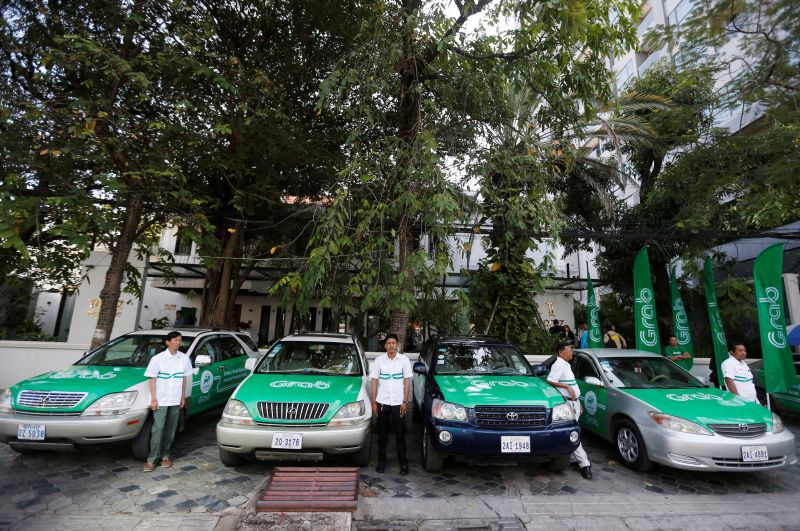 Drivers stand near Grab cars during a launch ceremony in Phnom Penh December 19, 2017. u00e2u20acu201d Reuters pic