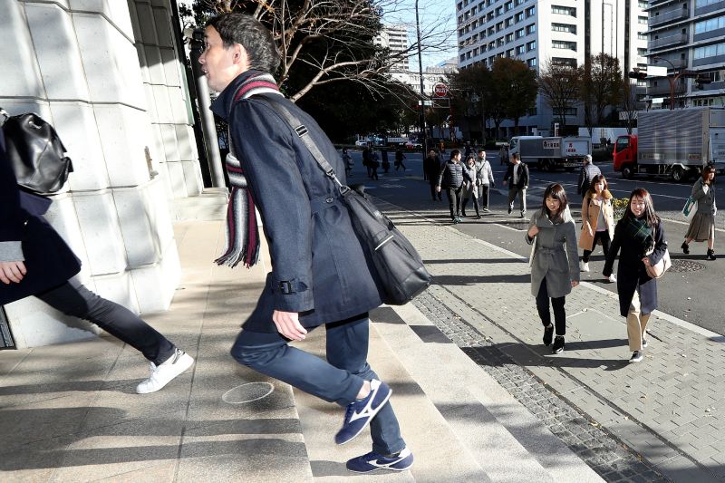 Officials from the Japan Sports Agency wear sneakers on their way to the office, as part of a campaign to promote fitness in Tokyo on December 6, 2017. u00e2u20acu201d AFP pic