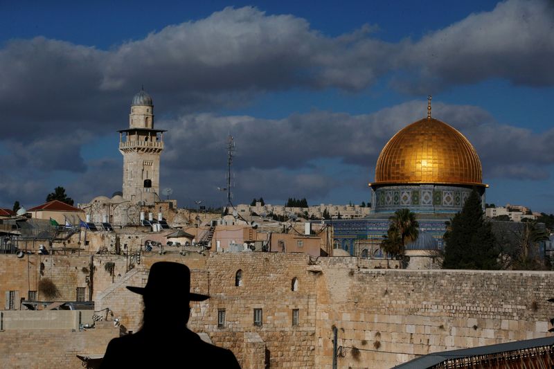 An ultra-Orthodox Jewish man is silhouetted beside the Dome of the Rock (right), located in Jerusalemu00e2u20acu2122s Old City on the compound known to Muslims as Noble Sanctuary and to Jews as Temple Mount, is seen in the background December 7, 2017. u00e2u20acu201d Reuters pic