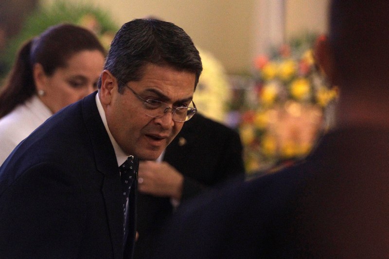 Honduras President Juan Orlando Hernandez talks with an unidentified person during a funeral mass for his late sister Hilda Hernandez in Tegucigalpa December 18, 2017. u00e2u20acu201d Reuters pic