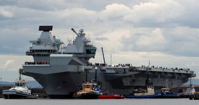 The British aircraft carrier HMS Queen Elizabeth is pulled from its berth by tugs before its maiden voyage, in Rosyth, Scotland June 26, 2017. u00e2u20acu201d Reuters pic