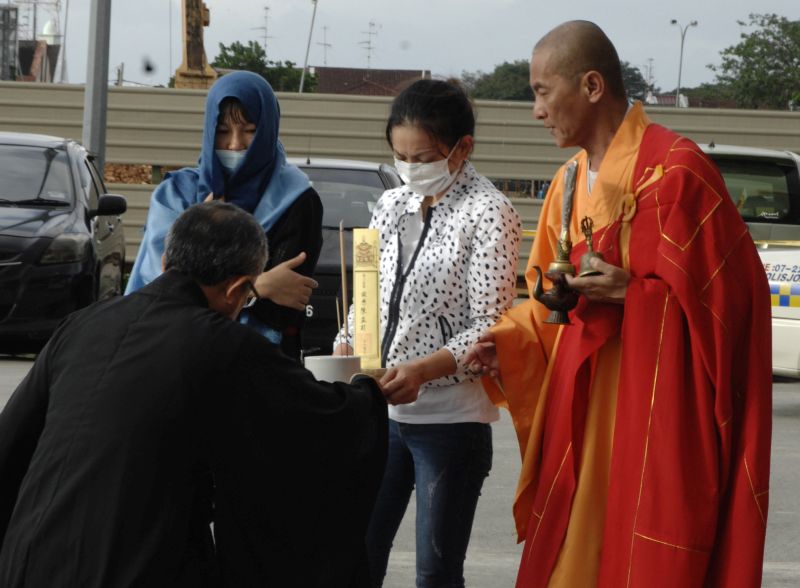 The two woman, known to murdered moneylender Tan Aik Chai, with a monk performing Taoist ceremony rites for the departed at the murder scene in Taman Pelang, Johor Baru December 19, 2017. u00e2u20acu201d Picture by Roslan Khamis