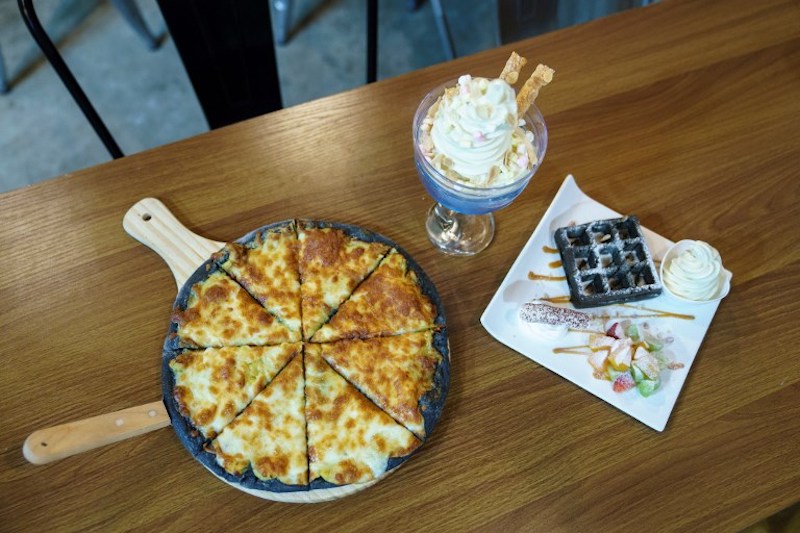 Various dishes including durian flavoured ice cream, waffles and pizza at Mao Shan Wang cafe in the Chinatown district of Singapore January 24, 2018. — AFP pic