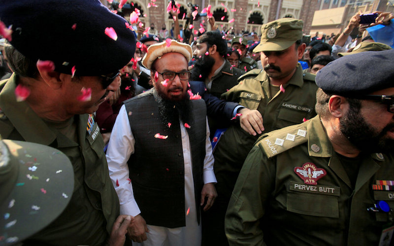Hafiz Saeed is showered with flower petals as he walks to court before a Pakistani court ordered his release from house arrest in Lahore November 22, 2017. u00e2u20acu201d Reuters pic