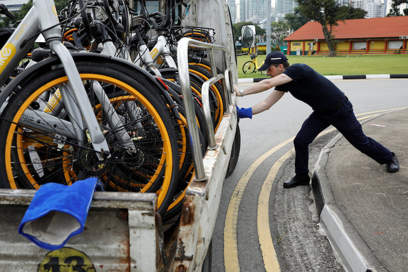 Zhivko Girginov, a Bulgarian living in Singapore, loads up damaged shared bicycles on his lorry to return them to a warehouse after gathering them around his neighbourhood in Singapore December 29, 2017. u00e2u20acu201d Reuters pic