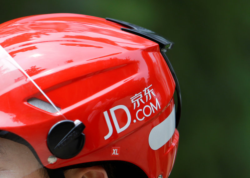 A logo of JD.com is seen on a helmet of a delivery man in Beijing June 16, 2014. u00e2u20acu201d Reuters pic