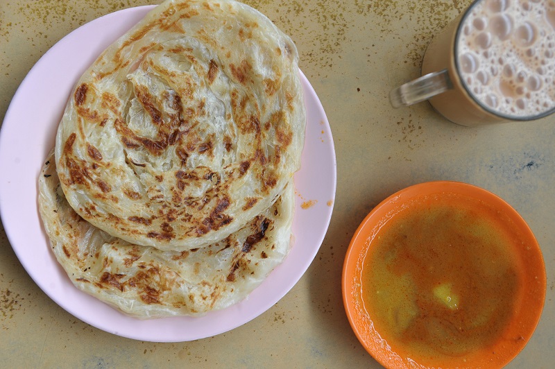 Crispy roti canai and teh tarik for breakfast at Restoran OMH.