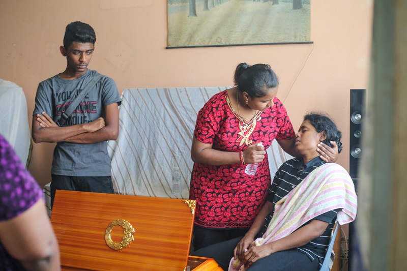 S. Kasthuri Bai (right) is comforted by relatives as she mourns the death of her 15-year-old son Satiswaran who was killed after he was hit by a falling chair at PPR Sri Pantai in Pantai Dalam January 17, 2018. u00e2u20acu201d Picture by Ahmad Zamzahuri
