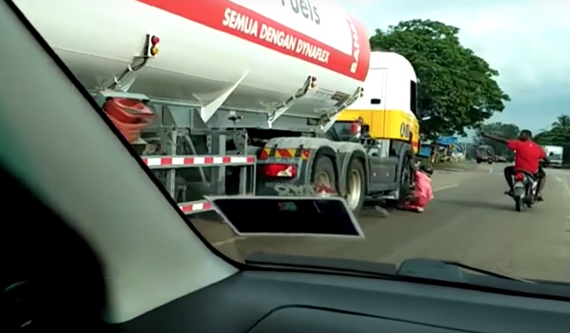 Screen capture of the video showing the man falling down, right before the oil tanker ran over his leg. 