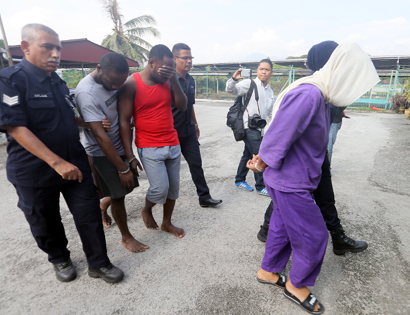 Eze Chimezie Kingsley, Anayo Apakabi, and Mazni Marzuki were charged at the Ipoh Magistrate Court today for cheating a man out of RM62,034. u00e2u20acu201d Picture by Farhan Najib