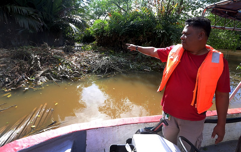 Kampung Dew Fireflies Tourism Association secretary Shukor Ishak, 48, points to the location where the berembang tree branches and  bark were dumped. u00e2u20acu201d Picture by Farhan Najib