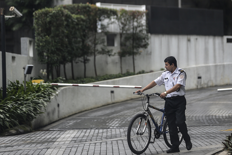 A security guard is seen at a middle-cost apartment in Petaling Jaya January 19, 2018. u00e2u20acu201d Picture by Azneal Ishak