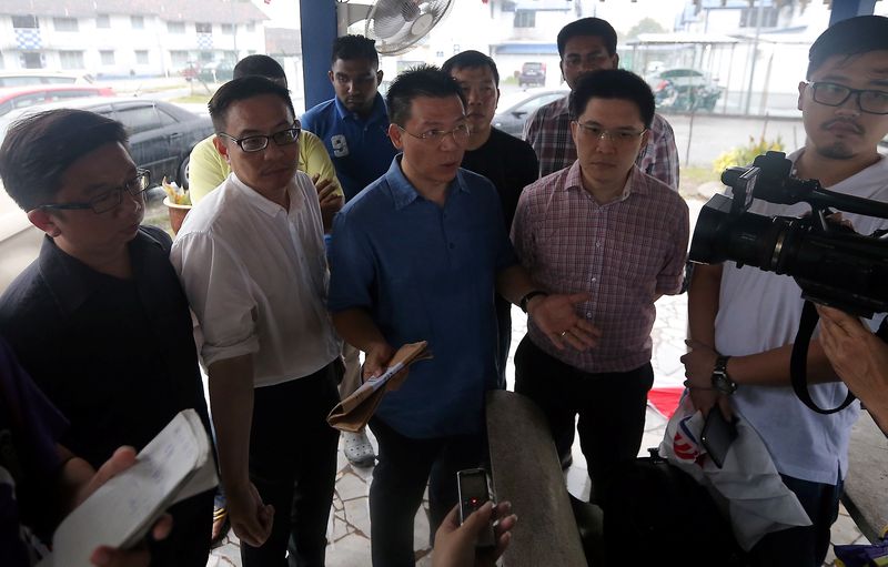 Perak DAP chairman Nga Kor Ming (centre) speaking to the press after having his statement recorded at the Sungai Senam police station, January 18, 2018, accompanied by fellow Opposition leaders. u00e2u20acu201d Picture by Farhan Najib