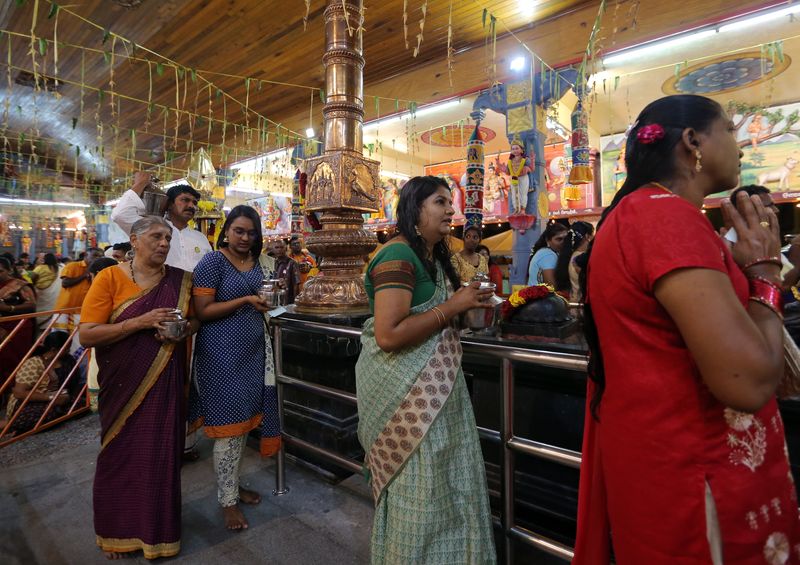 M. Indira Gandhi (in green dress) together with her eldest daughter Tevi Darsiny (in blue) and her mother S. Renggamah (in purple) carrying pots of milk at the Kallumalai Arulmigu Subramaniyar Temple in Ipoh, January 30, 2018. u00e2u20acu201d Picture by Farhan Najib