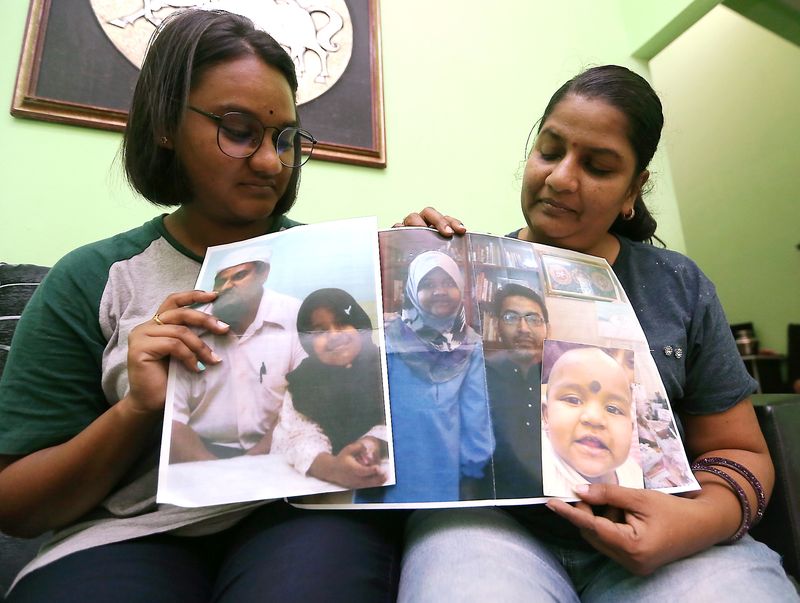 M. Indira Gandhi and her daughter Tevi Darsiny showing the only pictures they have of Prasana Diksa. u00e2u20acu201d Picture by Farhan Najib