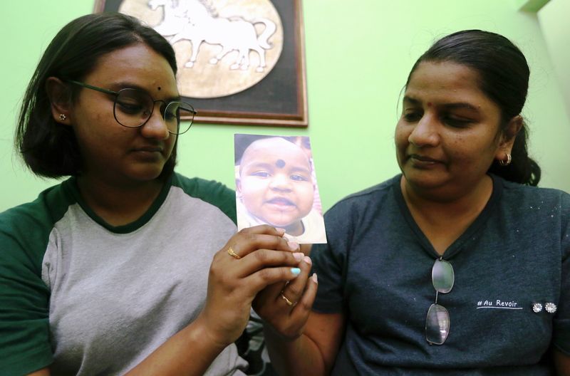 M. Indira Gandhi and her daughter Tevi Darsiny showing the only picture of Prasana Diksa, January 30, 2018, who has been taken away by her father when she was young. u00e2u20acu201d Picture by Farhan Najib
