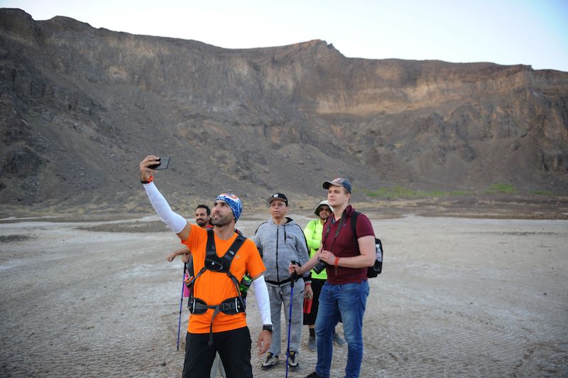 A Saudi guide takes a selfie as he leads a group of foreign tourists through the Al-Wahbah volcanic crater in the Al-Wahbah desert, some 360km northeast of Jeddah, on November 17, 2017. — AFP pic