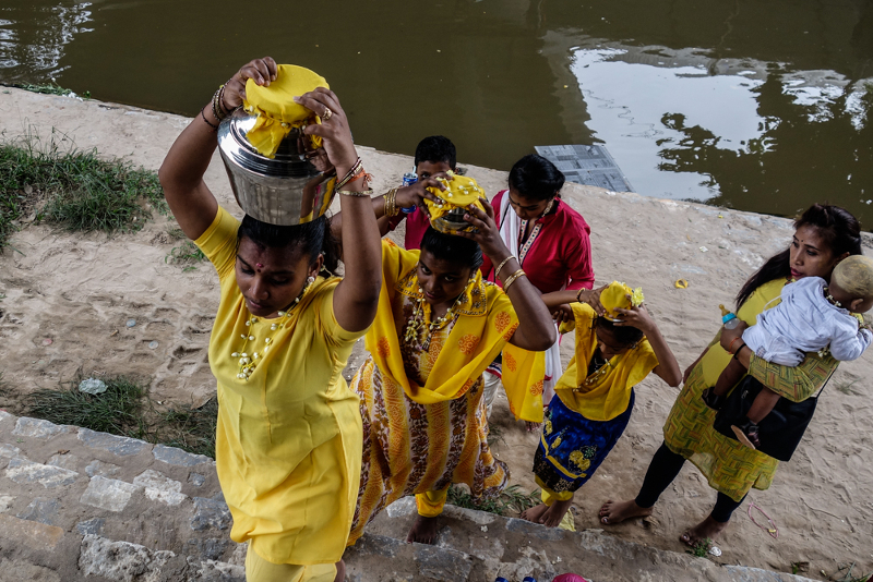 A group of devotees carry pots of milk to perform religious rites in Batu Caves several days before the Thaipusam festival January 21, 2018. u00e2u20acu201d Picture by Shafwan Zaidon