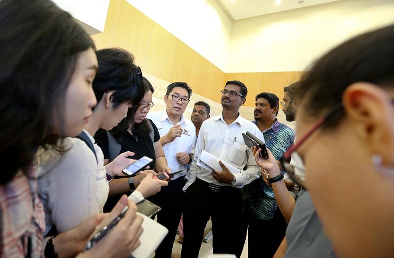 Bayan Baru Assemblymen Sim Tze Tzin (fourth left) speaks to the press during a visit to the State Registration Department, Federal Building, January 26, 2018. — Picture by Sayuti Zainudin
