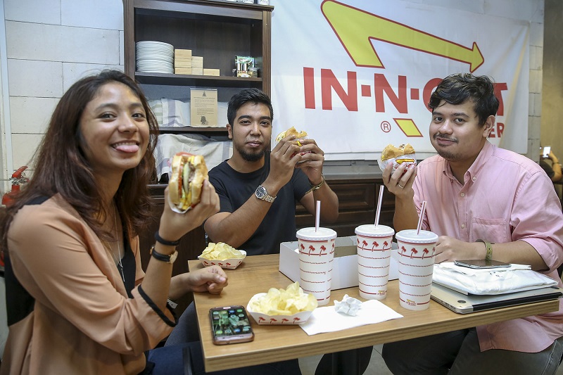 Customers enjoying their In-N-Out burger at Strangers at 47 in Petaling Jaya January 23, 2018.